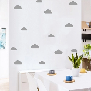 Detailed view of matte gray cloud wall decals applied on a minimalist dining room wall