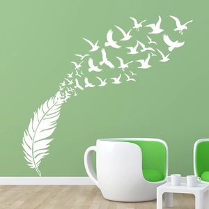 Creative white feather and bird wall decal on green wall with modern furniture
