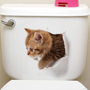 Close-up of 3D realistic orange tabby cat wall sticker with crack effect on white surface