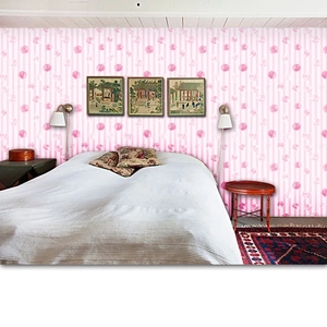 Detail of pink rose pattern and vertical stripes on self-adhesive floral wallpaper