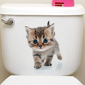 Detailed view of a cute tabby kitten wall sticker applied to a white bathroom toilet tank