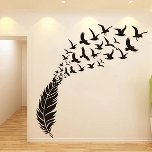Artistic vinyl wall decal featuring black feathers transforming into flying birds on wall