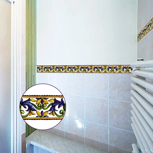 Detail of vintage floral self-adhesive wall tile sticker used as bathroom waistline border