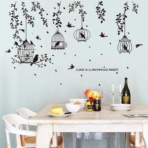 Detail of black birdcage and vine wall decals with quote Love is a perpetual belief