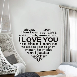 Detail of I LOVE YOU heart wall sticker above a modern woven hanging chair in home setting