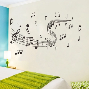 Detailed view of black musical notes and staff wall decal in a bedroom setting