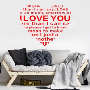 Detail showing red heart-shaped I LOVE YOU wall sticker above a modern sofa