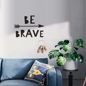 Inspirational Be Brave vinyl wall decal with arrow icons in a modern living room decor