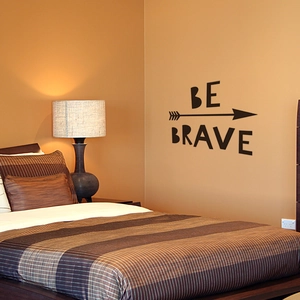 Inspirational BE BRAVE wall decal with arrow design above bedroom headboard