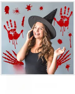 Detail of Halloween bloody handprint stickers and skeleton arm decals on a glass surface