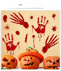 Bloody handprint and bone claw Halloween wall decals on a beige wall with pumpkins