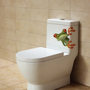 Funny 3D frog wall sticker applied on white toilet tank in a minimalist bathroom