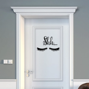 Creative black eyelash wall sticker with Shh... text on a modern white interior door