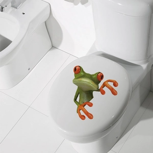 Detailed 3D cartoon red-eyed tree frog sticker applied on a white toilet lid cover