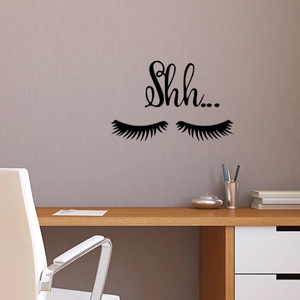 Minimalist black eyelash wall decal with Shh... text on a modern lavender interior wall