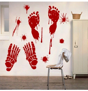 Detailed view of scary Halloween blood footprints and splatter stickers on a white wall