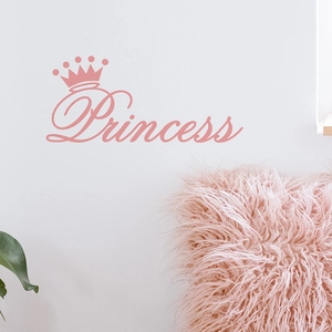 Close-up of pink Princess crown wall sticker on a white bedroom wall with plush decor