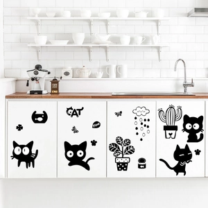 Minimalist black cat wall decals with potted plants on modern white kitchen cabinets