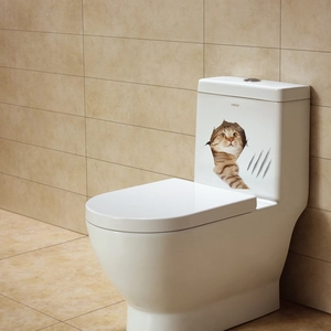 3D cat toilet sticker showing an orange tabby peeping through a cracked wall effect