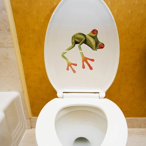 Detailed 3D effect green frog wall sticker on a white toilet lid for bathroom decor