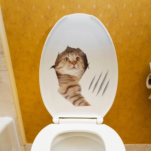 Detailed 3D orange tabby cat decal with realistic claw marks on a white toilet lid