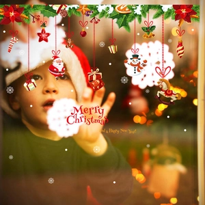 Close-up of Christmas window stickers with Santa, snowman and festive holiday greetings