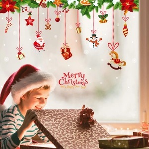Detailed view of Christmas window decals featuring Santa, snowman and festive holiday decorations
