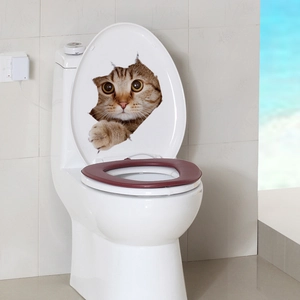3D orange tabby cat wall sticker appearing through a cracked hole on a white toilet lid
