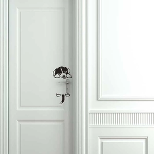 Detail of creative puppy light switch sticker on a white door showing cute peeking dog art