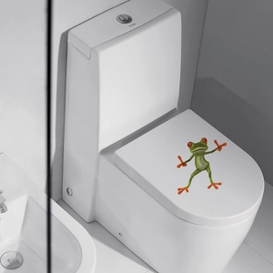 Detailed 3D funny green frog sticker showing realistic texture on a white toilet lid