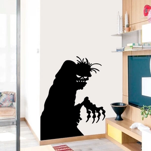 Black silhouette wall sticker featuring a scary Halloween monster with sharp claws on white wall