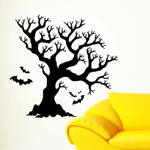 Detail of black Halloween bat and spooky tree wall stickers on a white wall
