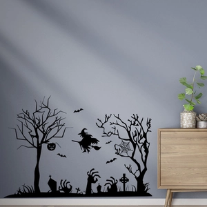Detail view of black Halloween wall decals featuring a witch, bats, and spooky dead trees