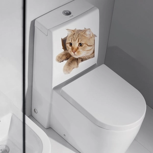Detail of 3D orange tabby cat toilet sticker with realistic cracked wall effect on white ceramic