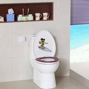 Close-up of a warm dark red toilet seat cover with a cartoon frog sticker detail