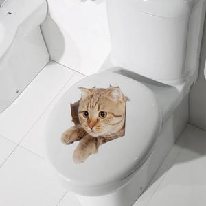 Detailed 3D orange tabby cat decal applied on a white ceramic toilet lid for decoration
