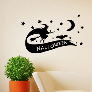 Detail of Halloween wall decal featuring a flying witch, moon, and bats on light wall
