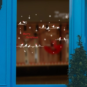 Christmas window stickers with white birds, snowflakes and Merry Christmas text on glass