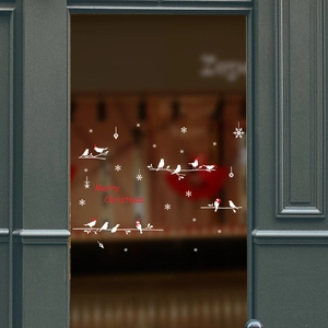Detail of Merry Christmas wall sticker with white birds and snowflakes on glass