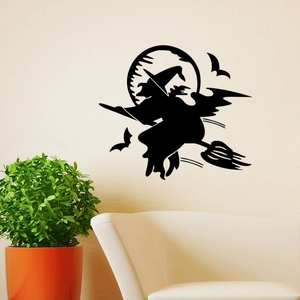 Close-up of a black Halloween wall decal featuring a witch silhouette on an ivory wall