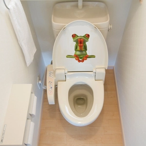 3D waterproof frog sticker showing a green tree frog in meditation pose on a toilet lid