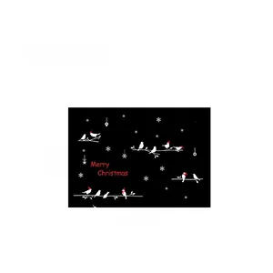 Close-up of Christmas wall stickers featuring white birds, snowflakes and Merry Christmas text
