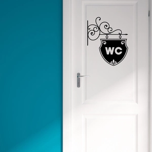 Vintage black WC wall sticker with elegant scroll patterns on a white wooden door