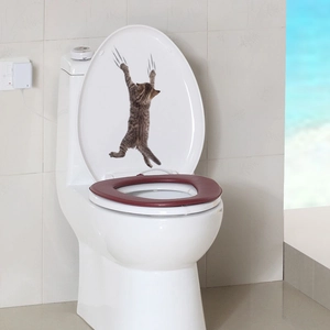 3D cartoon brown tabby cat wall sticker displayed on a white toilet lid in bathroom