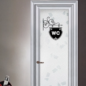 Vintage black iron style WC door sign sticker with scrolls on a white wooden door