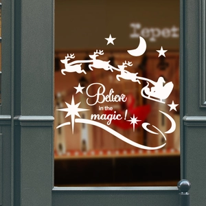 Detail of Christmas window sticker showing reindeer and 'Believe in the magic' text