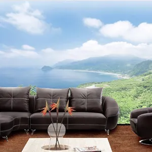 Deep brown leather sectional sofa with white stitching and polished metal legs for living room