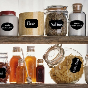 Macro view of black adhesive chalkboard labels on glass kitchen storage jars