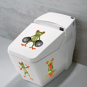 Vibrant cartoon red-eyed tree frog stickers applied on a modern white ceramic toilet tank