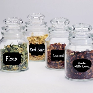 Set of 4 glass storage jars with lids and black chalkboard labels for kitchen organization
